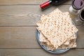 Stack of traditional matzos and red wine on wooden table, flat lay. Space for text Royalty Free Stock Photo