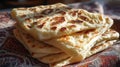 A stack of traditional Moroccan msemen flatbreads on a colorful patterned cloth, an authentic North African home cooking Royalty Free Stock Photo