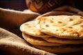 Stack of traditional naan bread on the table on served table. pita bread