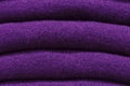 Stack of trend Ultra Violet woolen sweaters close-up, texture, background