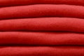 Stack of trend Valiant Poppy woolen sweaters close-up, texture, background
