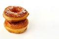 Stack of trendy delicious backed glassed dessert cronuts isolated on white background with copy Royalty Free Stock Photo