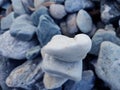 Stack of triangular stones.Group of white and colorful Stones.Pebble tower on the stones seaside.Stones pyramid on pebble beach