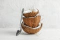 Stack tropical coconut with spoon on wooden table