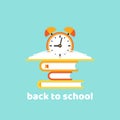 Stack of turquoise books with red alarm clock on powder blue background. Back to school concept Royalty Free Stock Photo