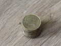 Stack of twenty euro cent coins on wooden background Royalty Free Stock Photo