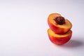Stack of two slice of peach nectarine fruit with seed on white background, copy space, angle view Royalty Free Stock Photo