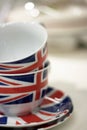 Stack of two Union Jack British Flag tea cups on matching saucers with pale background Royalty Free Stock Photo