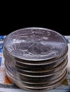 Stack of U.S. Silver Eagle coins on a hundred dollar bill Royalty Free Stock Photo