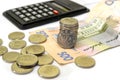 Stack of Ukrainian coins, hryvnia and calculator. Business concept. White background.