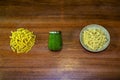 Stack of uncooked fusilli pasta, pesto, and cooked fusilli pasta dish. Royalty Free Stock Photo