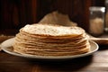 stack of uncooked tortillas on a plate