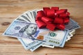 Stack of usa dollars and bow, Money gift, pile of cash with red bow Royalty Free Stock Photo