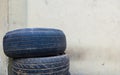 Stack of used secondhand tires on the corner of garage Royalty Free Stock Photo