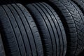 Stack of used tires at the tire fitting station. Royalty Free Stock Photo