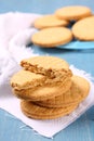 Stack of vanilla sandwich cookies on blue wooden background Royalty Free Stock Photo