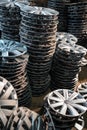 stack of various alloy wheels in tire store