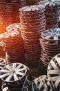 stack of various alloy wheels in tire store