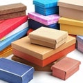 A stack of various-sized cardboard gift boxes in different colors and textures, perfect for gift-giving or retail displays Royalty Free Stock Photo