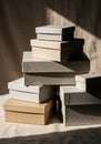 Stack of variously sized and colored cardboard gift boxes, including beige and light Royalty Free Stock Photo