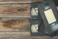 Stack of VHS video tape cassette over wooden background. top view photo