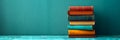 Stack of vibrant books. A neat pile of vintage reading books on green background. Concept of academic collection