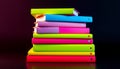 Stack of vibrantly colored books create an inviting and playful atmosphere, with a dark background Royalty Free Stock Photo