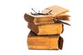 Stack of vintage books and glasses on white background Royalty Free Stock Photo