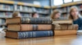Stack of Vintage Books in a Library with Students in the Background concept study leering library book history Royalty Free Stock Photo