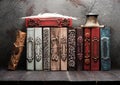 Stack vintage books on a wooden shelf,.inkwell and feather. Royalty Free Stock Photo