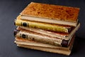 A stack of vintage dilapidated books on a dark concrete table Royalty Free Stock Photo