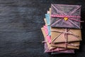 Stack of vintage envelopes tied with string and heart-shaped decoration on dark table Royalty Free Stock Photo