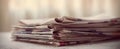 The stack of vintage newspapers resting on a cozy table. AI generated image Royalty Free Stock Photo