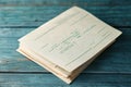 Stack of vintage papers on rustic blue wooden surface. Nostalgic stationery and paperwork concept Royalty Free Stock Photo