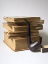 Stack of old books and a pipe Royalty Free Stock Photo