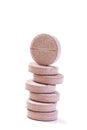 Stack of vitamin mineral supplement effervescent tablets on a white background
