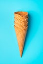 A stack of waffle cones for ice cream on a blue background. Royalty Free Stock Photo