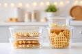 Stack of waffles in transparent storage containers on kitchen countertop Royalty Free Stock Photo