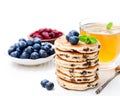 Stack of welsh cakes with blueberry and a cup of green tea Royalty Free Stock Photo