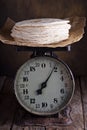 Stack of wheat tortillas on vintage kitchen scales Royalty Free Stock Photo