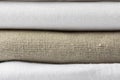 Stack of white and beige pure organic cotton and linen folded fabric. Clothing laundry home textile concept