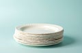 Stack of white biodegradable plates on pastel background. Eco friendly disposable dishware for picnics, parties, takeout meals. Royalty Free Stock Photo