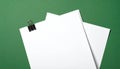 Stack of white blank paper sheets secured by a black binder clip Royalty Free Stock Photo