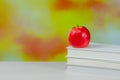 Stack of white books with juicy fresh apple on desktop over blurry autumn background. Back to school Royalty Free Stock Photo