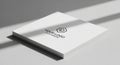 A stack of white business cards rests on a light gray surface, with shadows cast across them. The Royalty Free Stock Photo