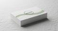 Stack of white business cards with a subtle green wave design and \' Mockup\' text pile Royalty Free Stock Photo