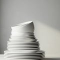 A stack of white ceramic bowls and plates is arranged on a table. The dishes are Royalty Free Stock Photo