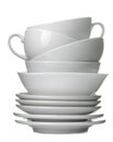 A stack of white ceramic dishes, plates, saucers, cups on a white isolated background Royalty Free Stock Photo