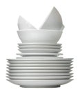 A stack of white ceramic dishes, plates, saucers, cups on a white isolated background Royalty Free Stock Photo