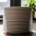 A stack of white ceramic plates is placed on a wooden surface near a window. Sunlig Royalty Free Stock Photo